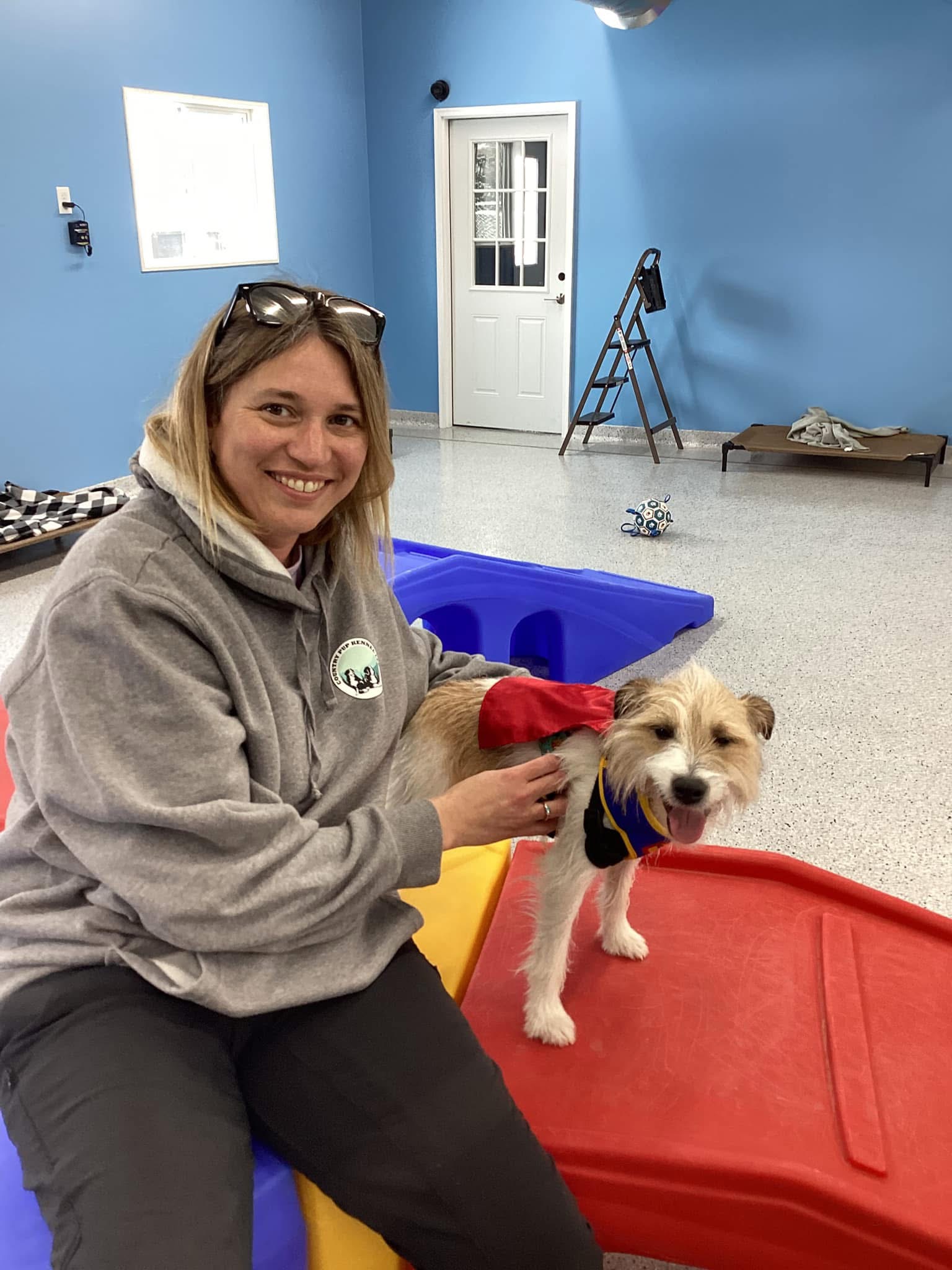 Country Pup Kennel Indoor Playtime Country Pup Kennel staff playing with a daycare dog in the indoor play area.
