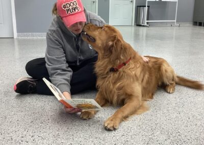 Country Pup Kennel staff reading to a dog.